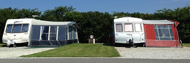 Spacious individual caravan pitches with parking alongside