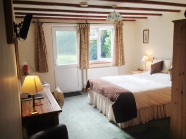 Lodge bedroom at the Crown Inn furnished with King-sized bed