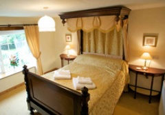 Canopied double bed in Millers Cottage