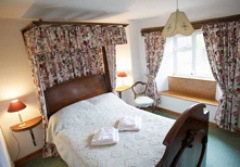 Canopied double bed in Dairymaids Cottage