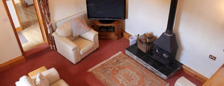 The living area with woodburner in one of our holiday cottages