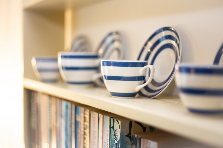 The cottage has homely touches including a display of Cornishware