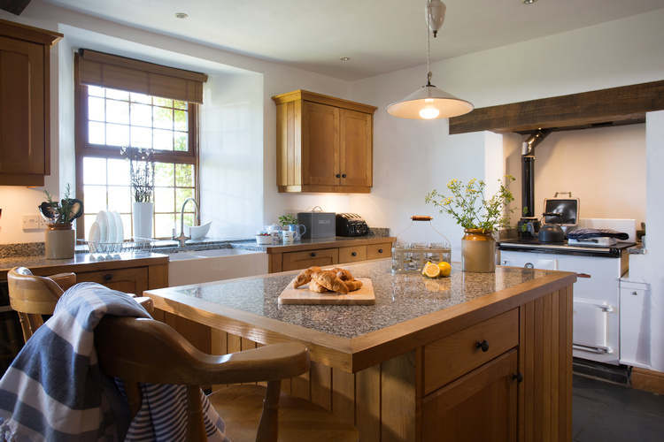 Farmhouse kitchen with granite worktops and Rayburn