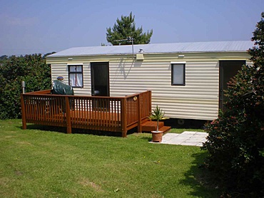 A static caravan with a patio area