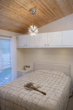 Double bed with fitted cupboards above
