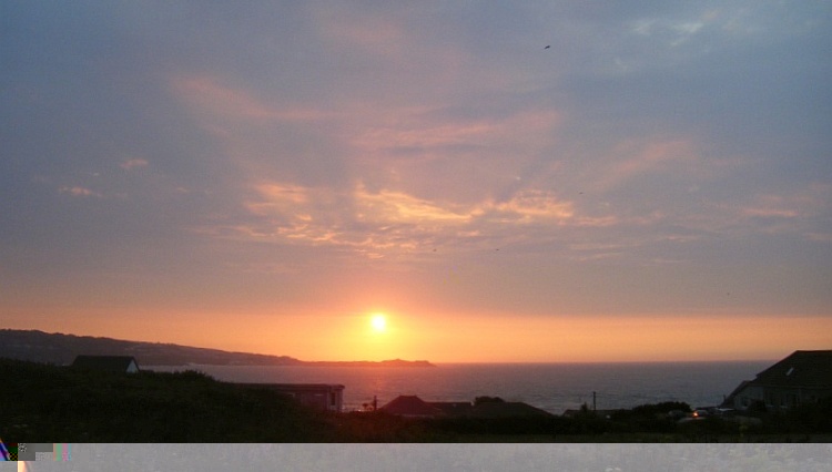 The sun setting over St Ives Bay in front of Branksome Chalet
