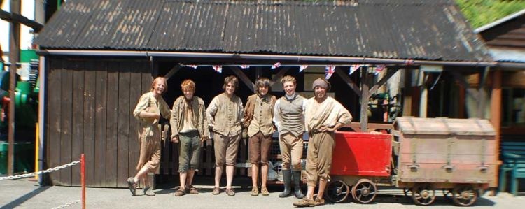Some of the cast of the TV Series Poldark in front of the mine